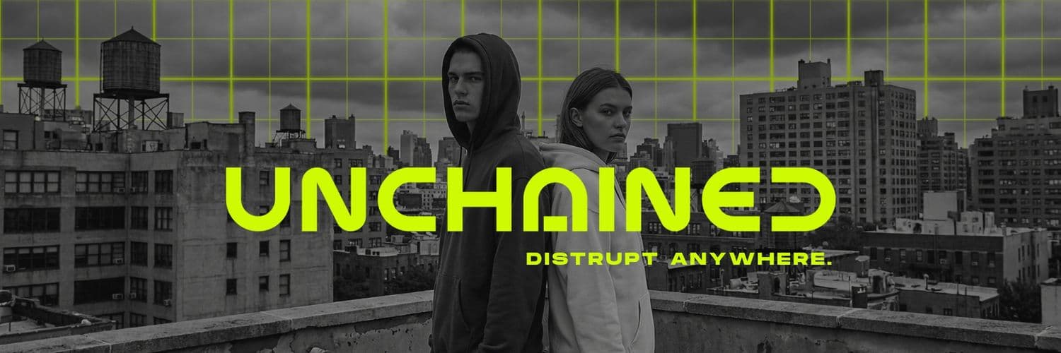 UNCHAINED campaign banner showing two people in hoodies against a city skyline